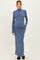 woman wearing a blue long sleeve maternity dress with a turtleneck and a visible baby bump
