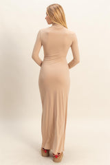 woman wearing a form-fitting beige long sleeve maxi dress, showcasing a sleek silhouette from the back