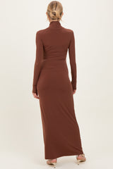 woman wearing a brown long sleeve maternity maxi dress, showing the back view with a fitted silhouette