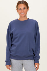 woman wearing a navy blue oversized sweatshirt with long sleeves and crew neckline