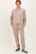 woman wearing a beige oversized sweatshirt and matching sweatpants with pockets and elastic cuffs