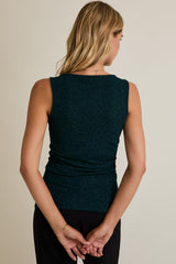 woman wearing a teal sleeveless top with a ruched back and subtle glitter details