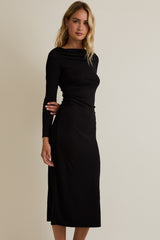 woman wearing a black long sleeve midi dress with a gathered side detail
