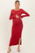 woman wearing a red long sleeve maternity maxi dress with a side slit and holding her baby bump