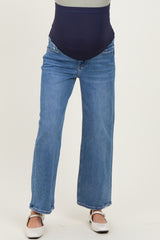 woman wearing a pair of light blue maternity jeans with a stretchy navy belly panel