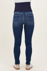 woman wearing dark blue maternity jeans with a supportive belly band, viewed from the back