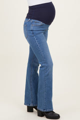 woman wearing dark wash maternity flared jeans with a navy blue waistband and visible baby bump