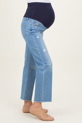woman wearing light blue maternity jeans with a dark blue belly panel and distressed details, showing her baby bump