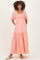 woman wearing a light pink maternity maxi dress with puff sleeves and floral embroidery