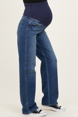 woman wearing dark blue maternity jeans with a supportive belly panel and flat front, paired with black sneakers