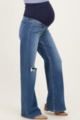 maternity wear blue distressed flare jeans with a black over-the-bump panel and visible baby bump
