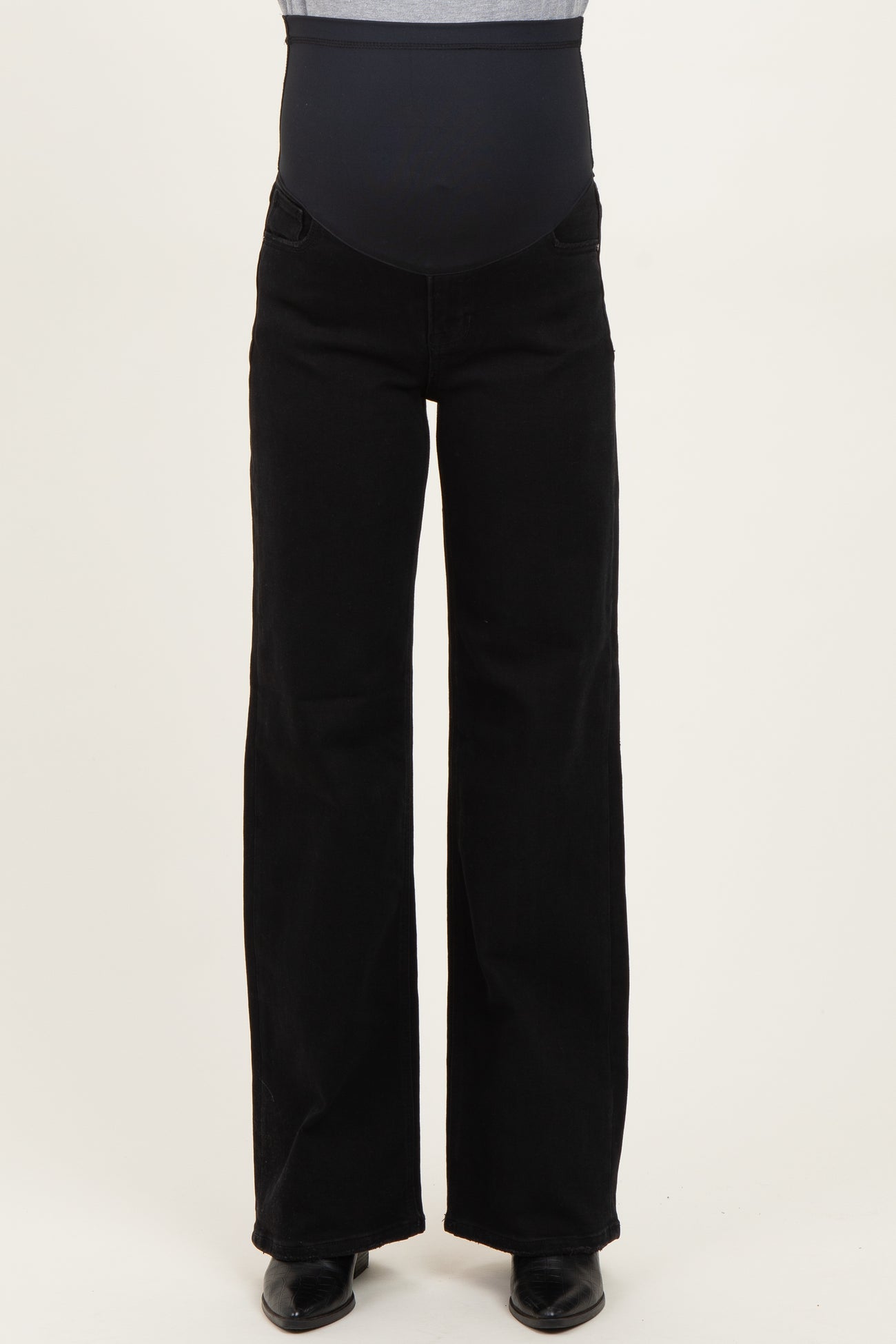 maternity wear black wide-leg pants with a supportive over-the-bump belly panel, styled with a fitted top