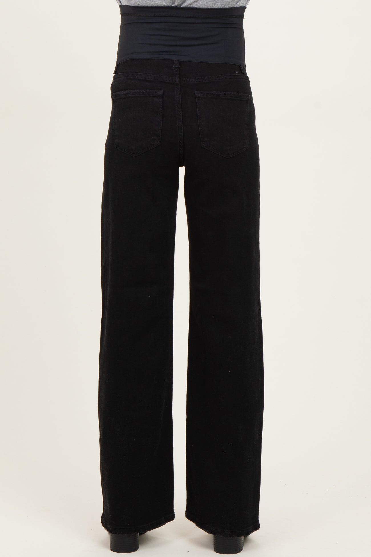 maternity wear black wide-leg jeans with a stretchy belly panel, shown from the back