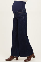 woman wearing dark blue maternity wide-leg jeans with a supportive belly panel and a visible baby bump
