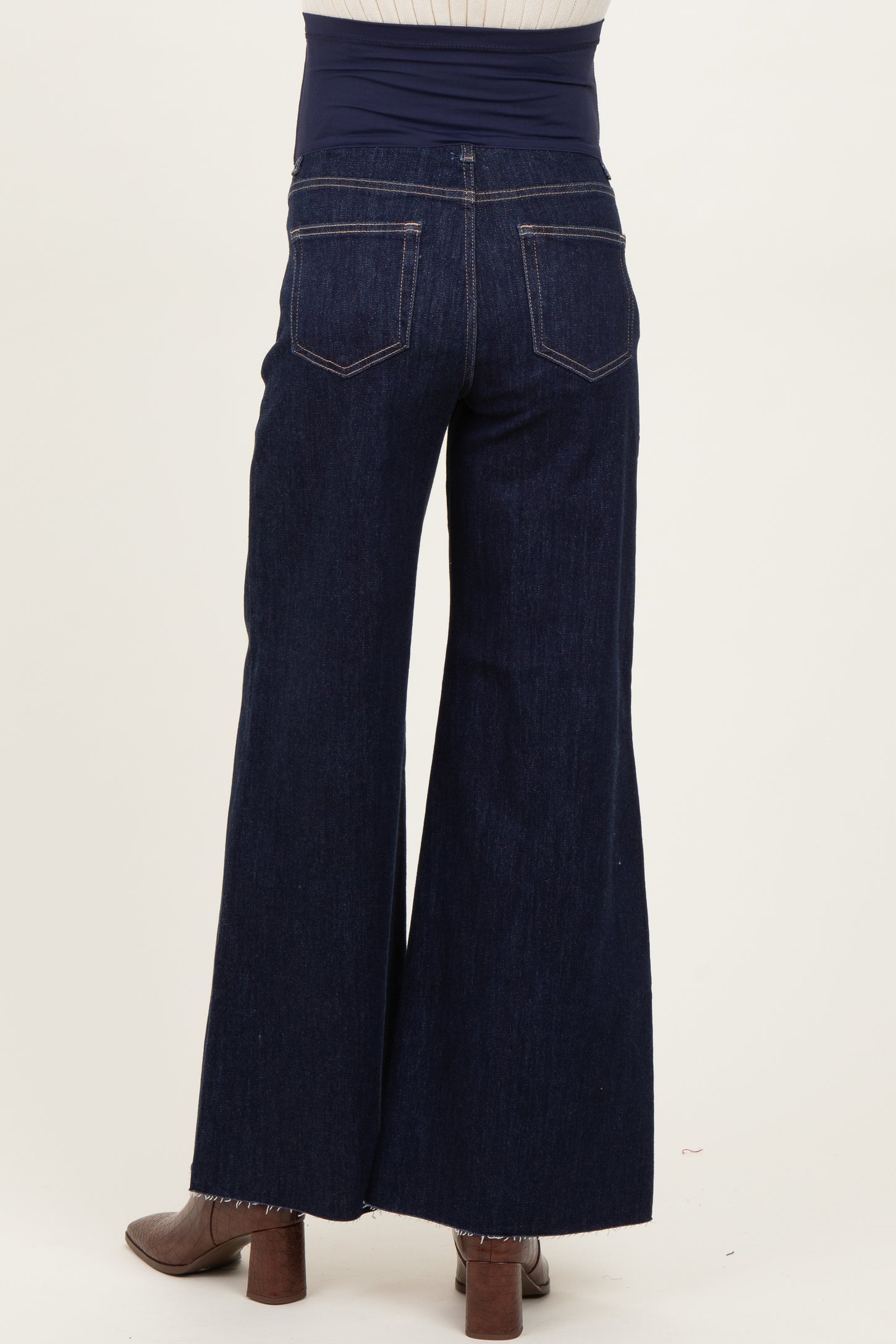 woman wearing dark blue maternity wide leg jeans with a stretchy waistband, viewed from the back