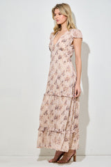 woman wearing a floral print maxi dress with ruffle sleeves and tiers, styled with beige heels