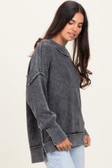 woman wearing a dark gray ribbed oversized sweater with a relaxed fit and long sleeves