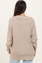 woman wearing a beige ribbed oversized sweater with a relaxed fit