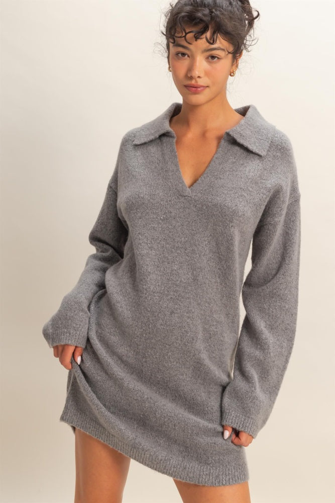 woman wearing a gray knit sweater dress with a collar and long sleeves