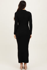 woman wearing a black ribbed knit maxi dress with long sleeves, shown from the back