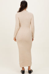 woman wearing a beige ribbed knit maxi dress with long sleeves and a fitted silhouette, viewed from the back