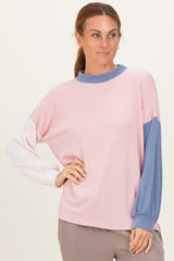 woman wearing a pink and blue color block long sleeve top with ribbed texture and relaxed fit