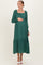 woman wearing a dark green maternity maxi dress with puffed sleeves and gathered bodice, showing her baby bump