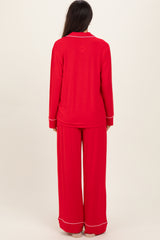 woman wearing a red long sleeve pajama set with matching wide-leg pants, seen from the back