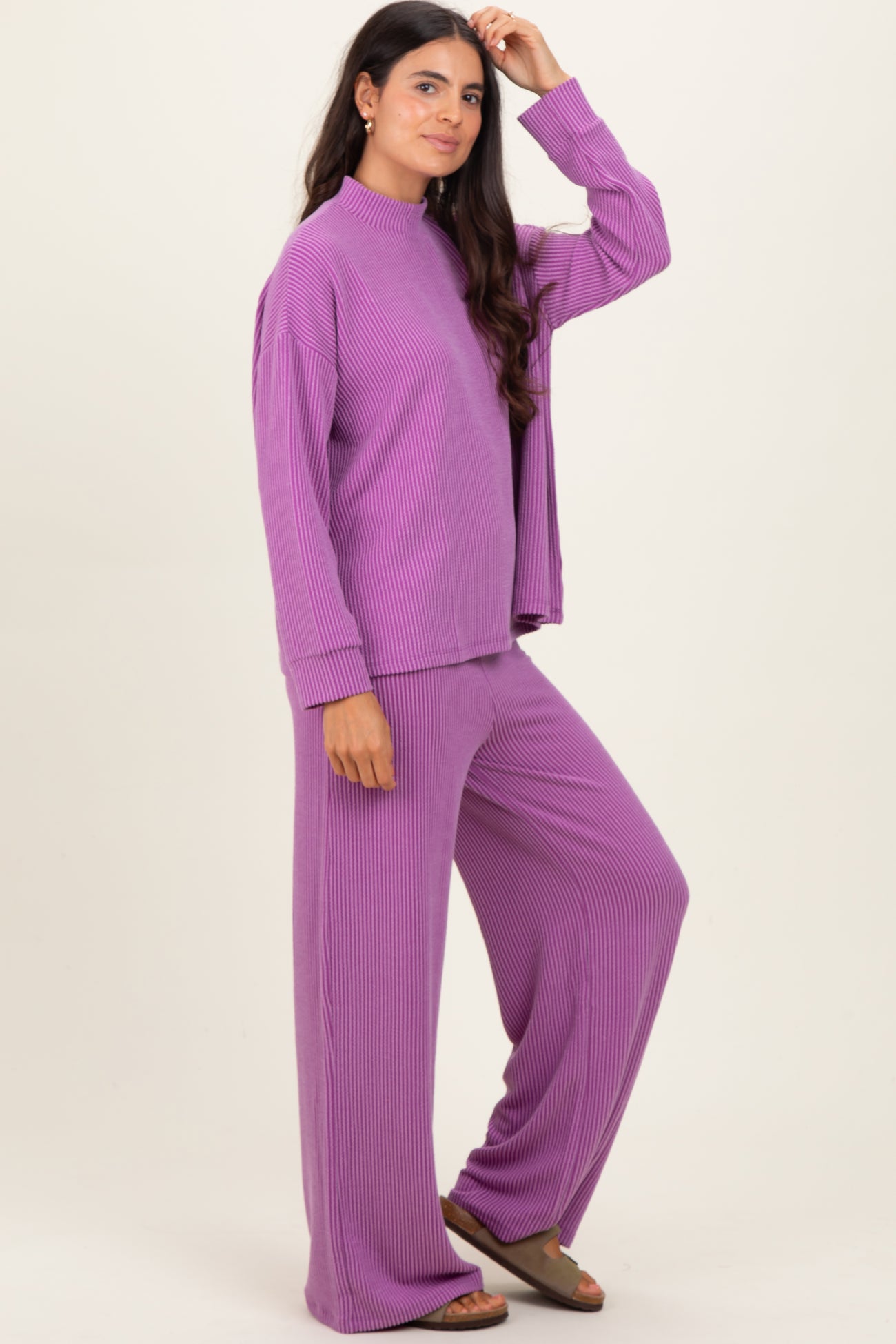 woman wearing a purple ribbed loungewear set with a mock neck top and wide-leg pants