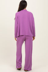woman wearing a purple ribbed two-piece lounge set with a loose-fitting top and wide-leg pants