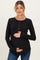 woman wearing a black long sleeve maternity top with button details and holding her baby bump