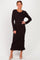 woman wearing a black long sleeve ribbed knit dress with ruffled hem and a fitted silhouette
