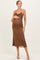 woman wearing a brown ribbed maternity dress with adjustable straps and a baby bump visible