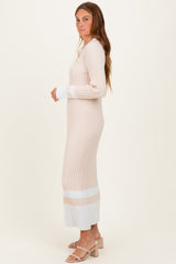 woman wearing a ribbed beige and white long sleeve sweater dress with a fitted silhouette and side slits