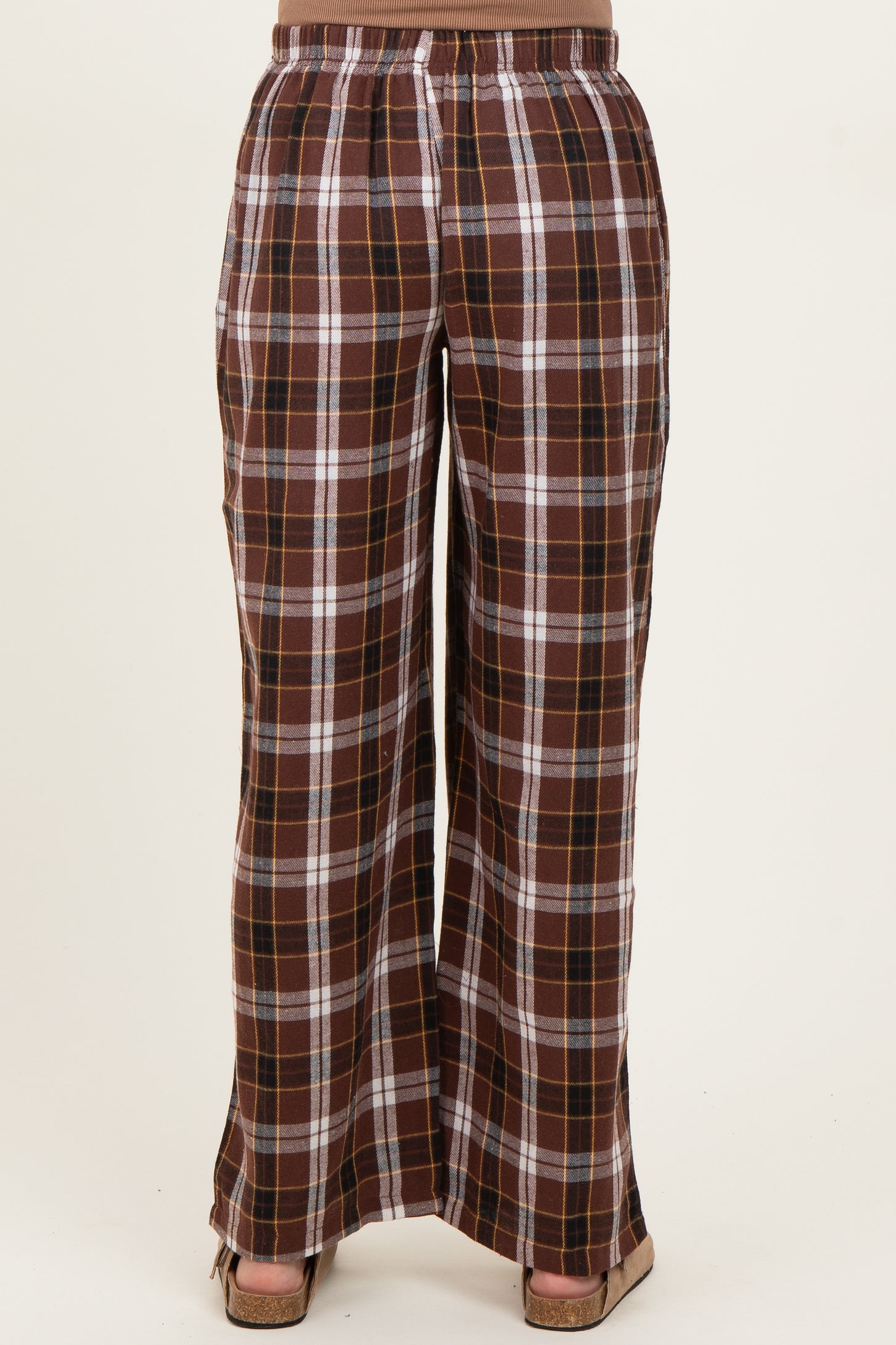 woman wearing brown and plaid maternity pants with an elastic waistband