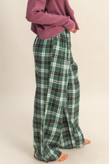 woman wearing green and navy plaid wide-leg pants with an elastic waistband and a relaxed fit