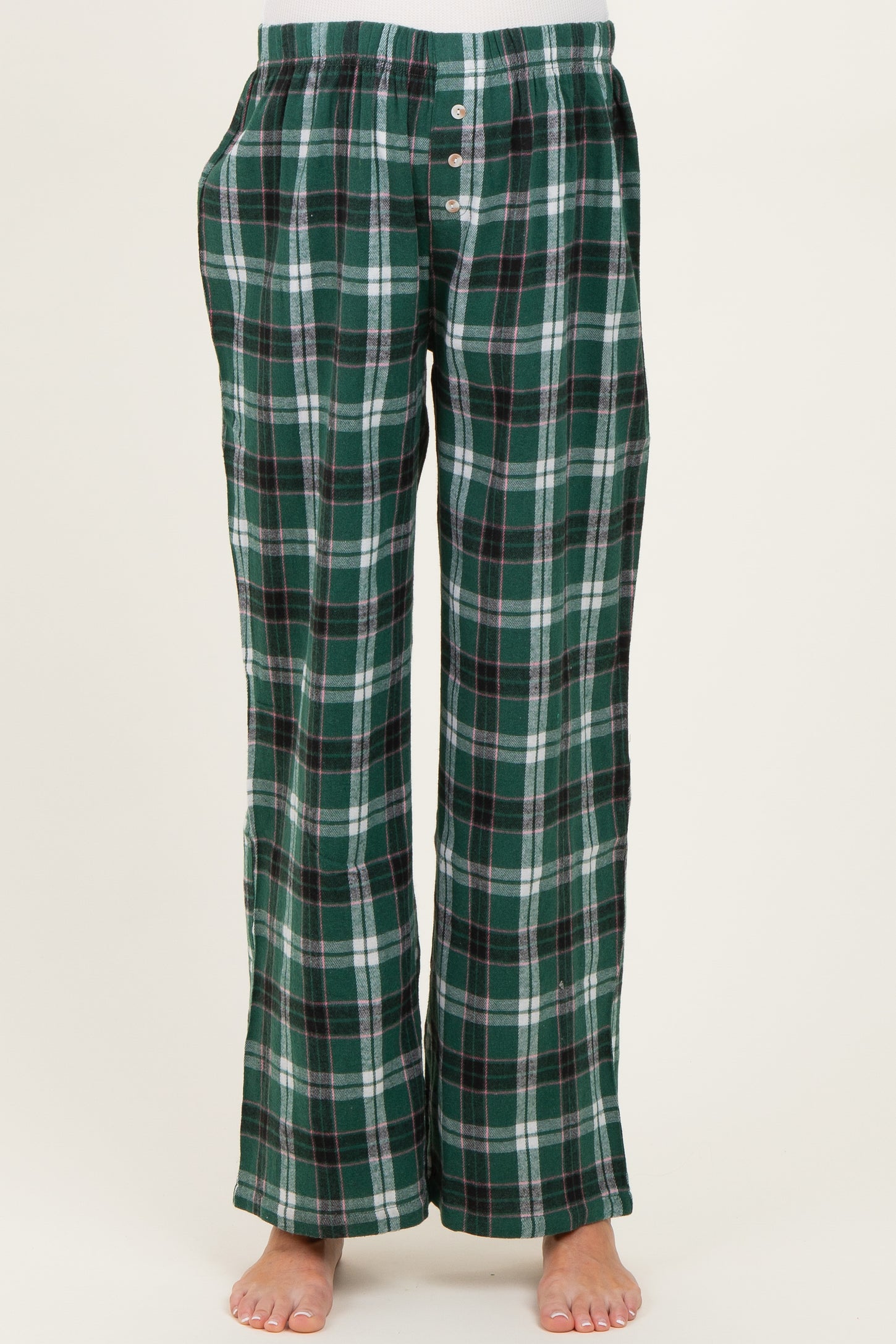 maternity wear green and navy checkered pajama pants with a relaxed fit and button details, model standing barefoot