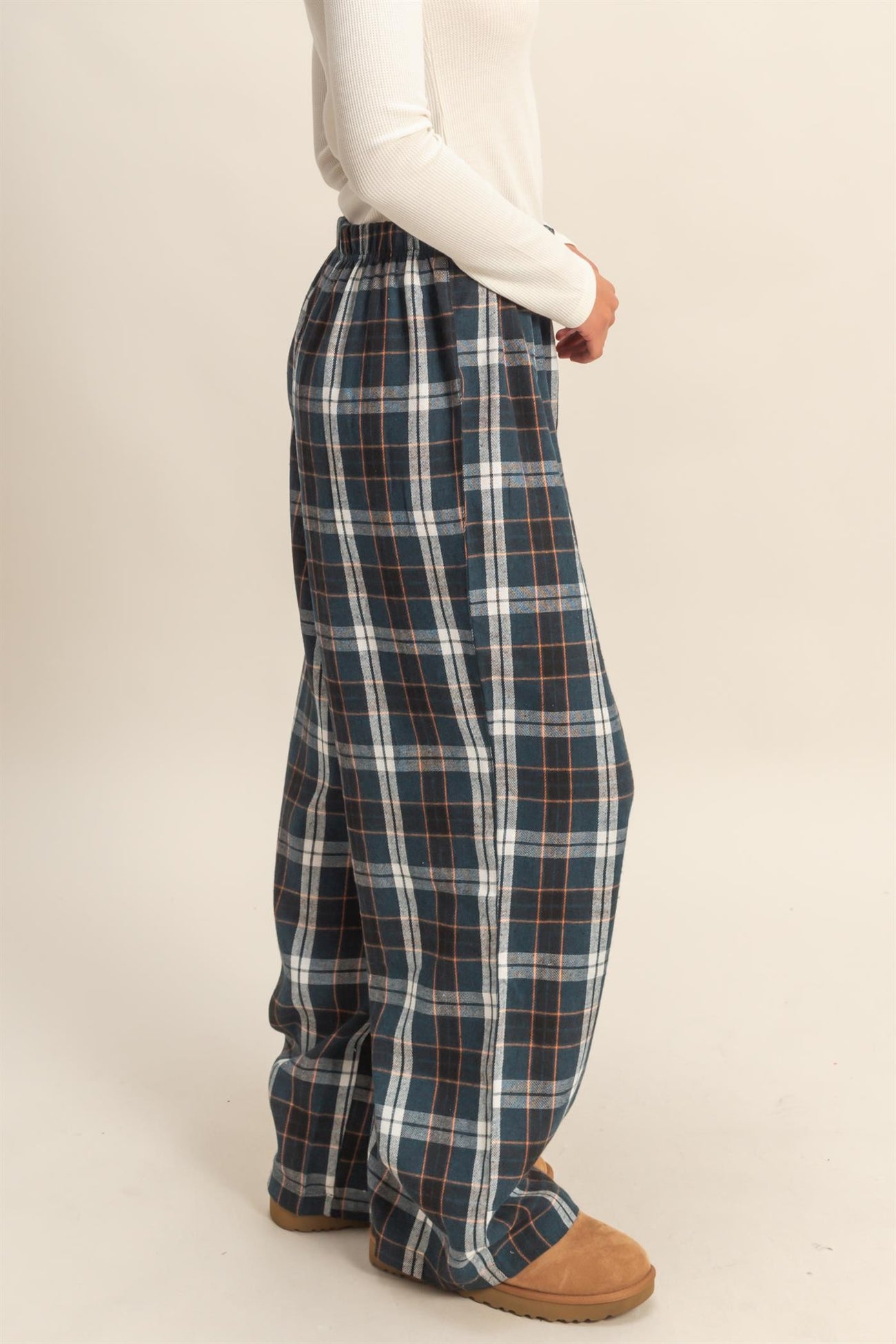 woman wearing navy blue and white plaid wide leg lounge pants with an elastic waistband
