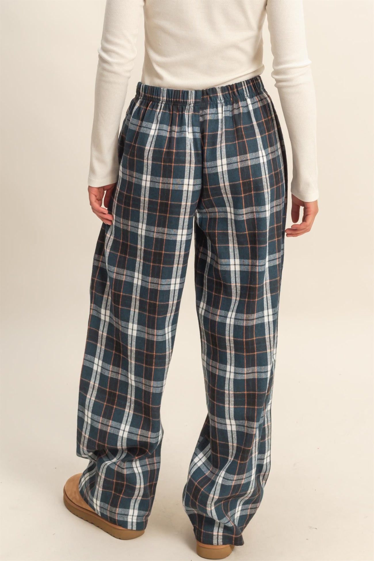 woman wearing blue and white plaid wide-leg pants with an elastic waistband, view from the back