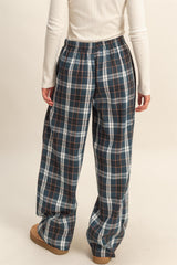 woman wearing blue and white plaid wide-leg pants with an elastic waistband, view from the back
