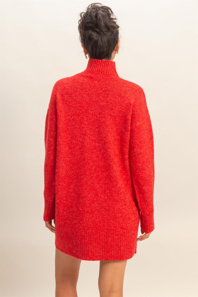 woman wearing a red oversized turtleneck sweater dress with long sleeves, seen from the back