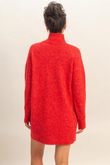 woman wearing a red oversized turtleneck sweater dress with long sleeves, seen from the back