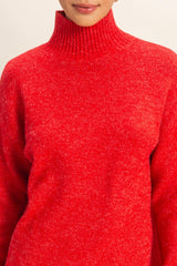 woman wearing a bright red cozy turtleneck sweater