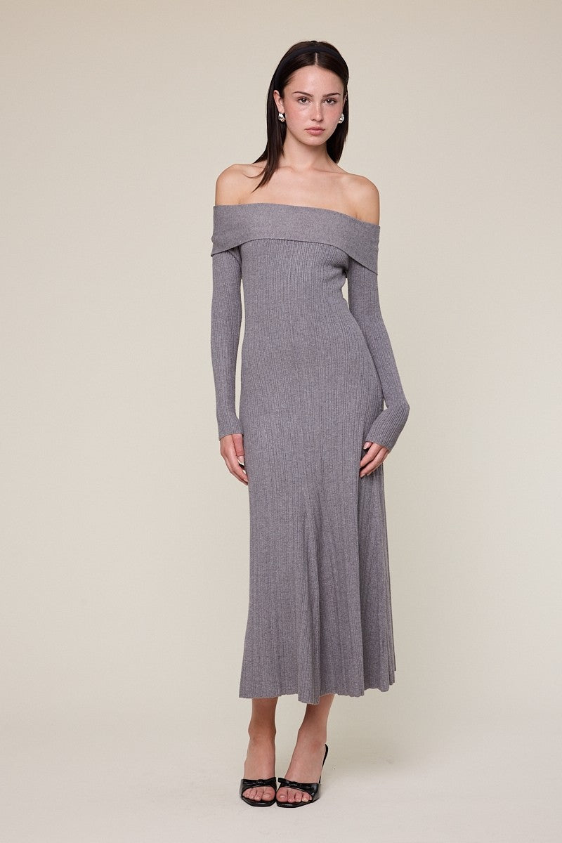 woman wearing a gray off-the-shoulder ribbed knit maxi dress with long sleeves and a fitted silhouette