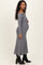 woman wearing a grey ribbed off-the-shoulder maternity dress, showcasing her baby bump while standing sideways