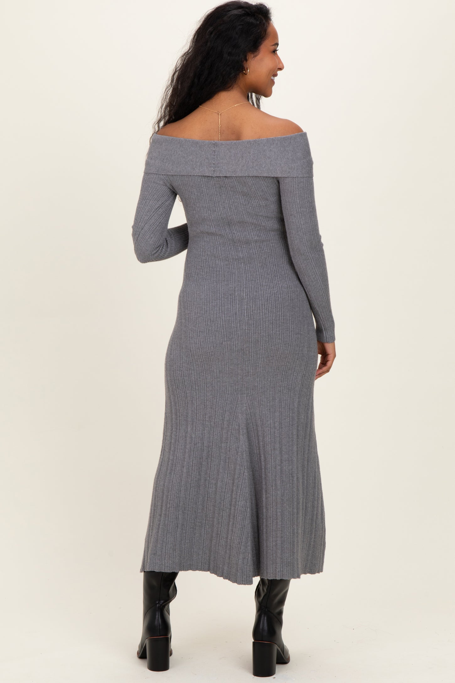 woman wearing a fitted gray off-the-shoulder maternity dress with long sleeves and a ribbed texture