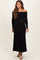 woman wearing a black off-the-shoulder ribbed maternity dress, showing her baby bump