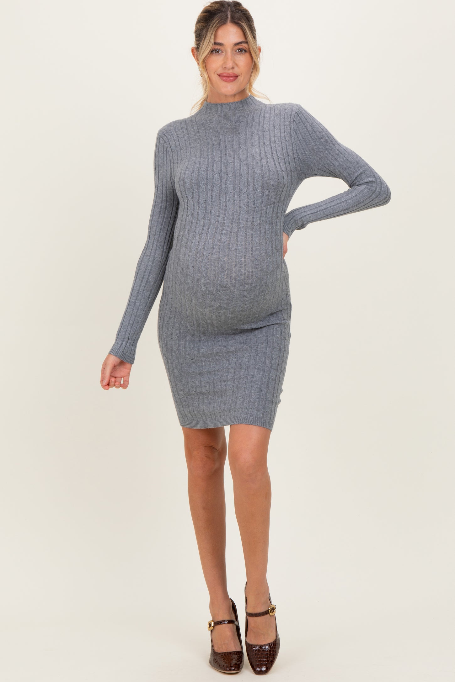 woman wearing a gray ribbed maternity dress that hugs her baby bump and features long sleeves