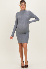 woman wearing a gray ribbed maternity dress that hugs her baby bump and features long sleeves