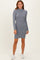 woman wearing a gray ribbed long sleeve sweater dress paired with white sneakers